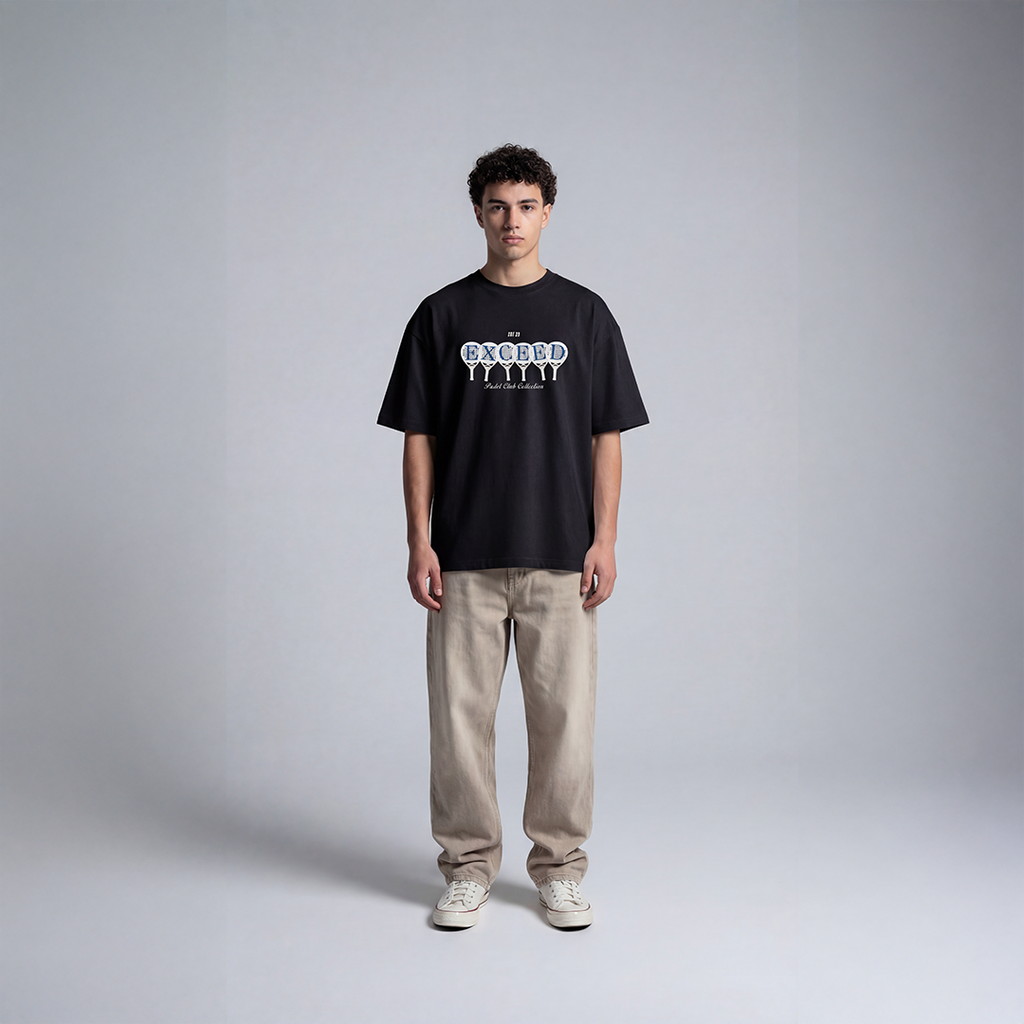 Black graphic padel tee with EXCEED graphic design featuring padel rackets and Padel Club Collection text

