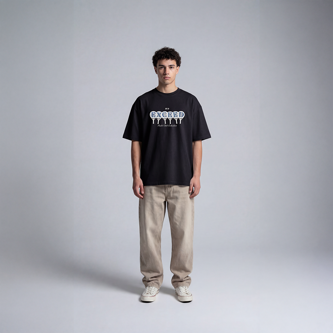 Black graphic padel tee with EXCEED graphic design featuring padel rackets and Padel Club Collection text

