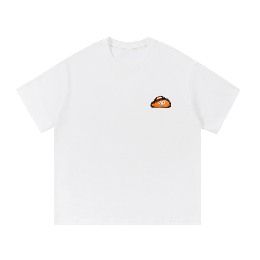 White streetwear tee with small orange padel bag logo on chest EXCEED Studios design