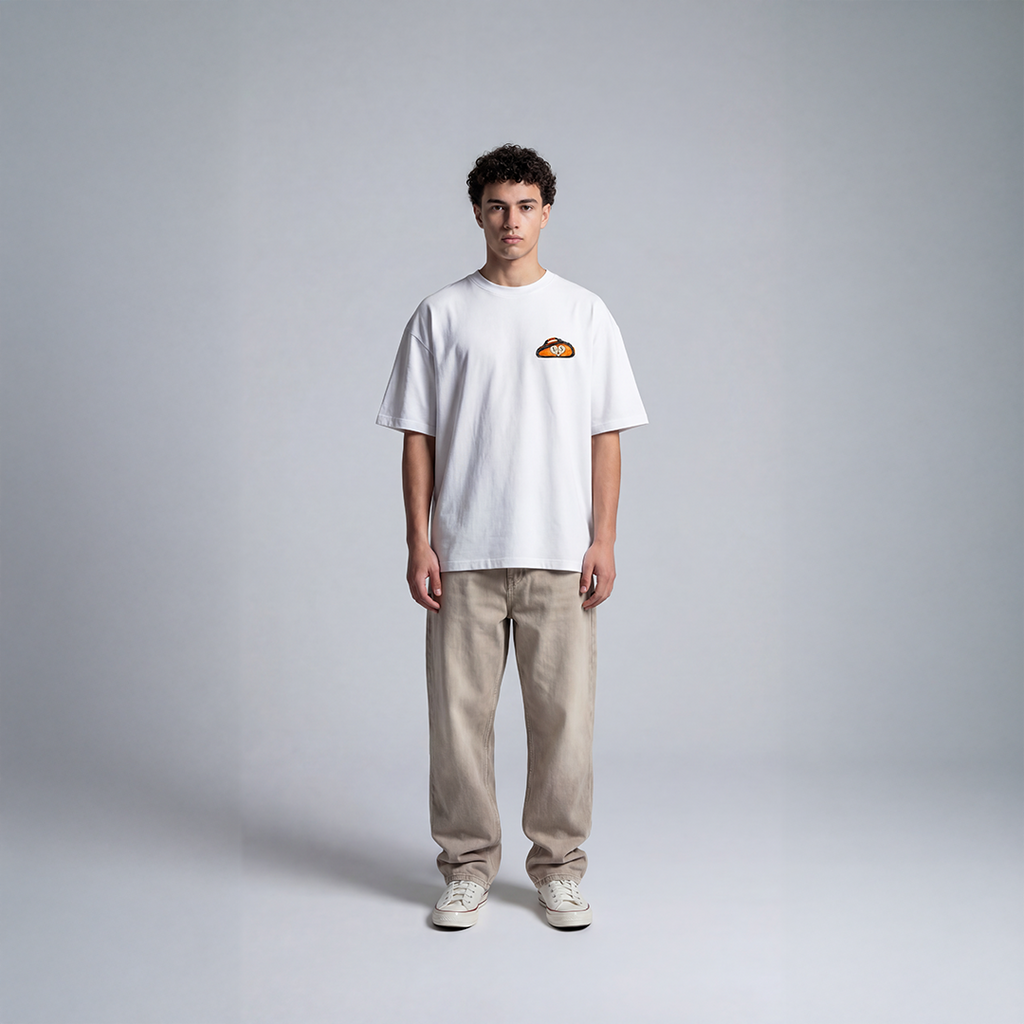 White streetwear tee with small orange padel bag logo on chest EXCEED Studios design
